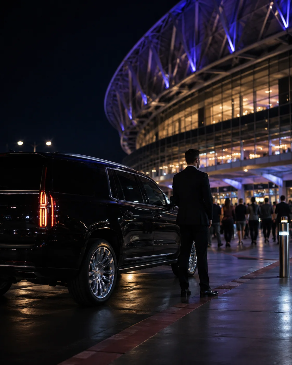 Luxury SUV waiting outside a major arena at night